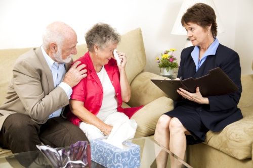 therapist helping a senior woman suffering from depression